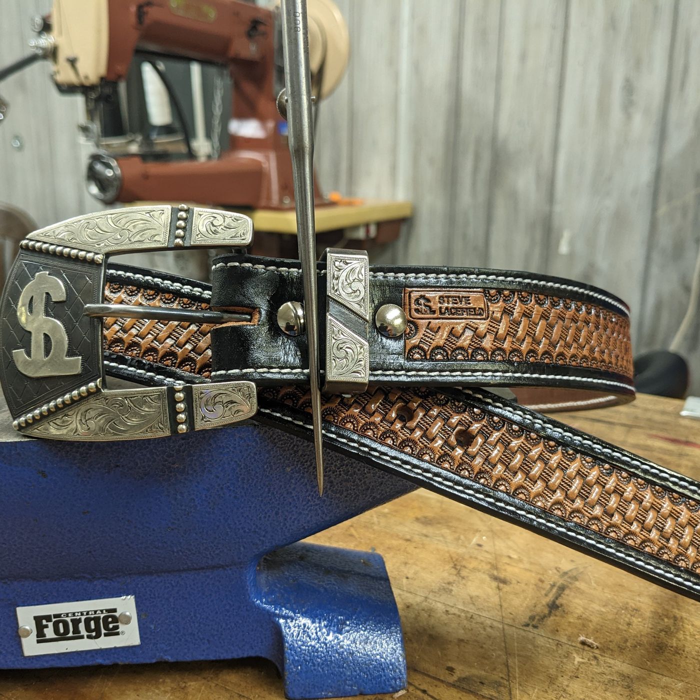 Basket-stamped belt with engraved silver buckle