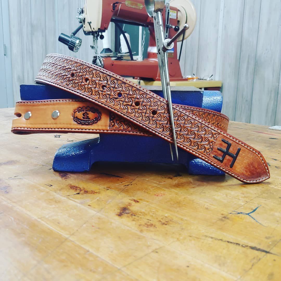 Tan stamped leather belt with H brand on tip