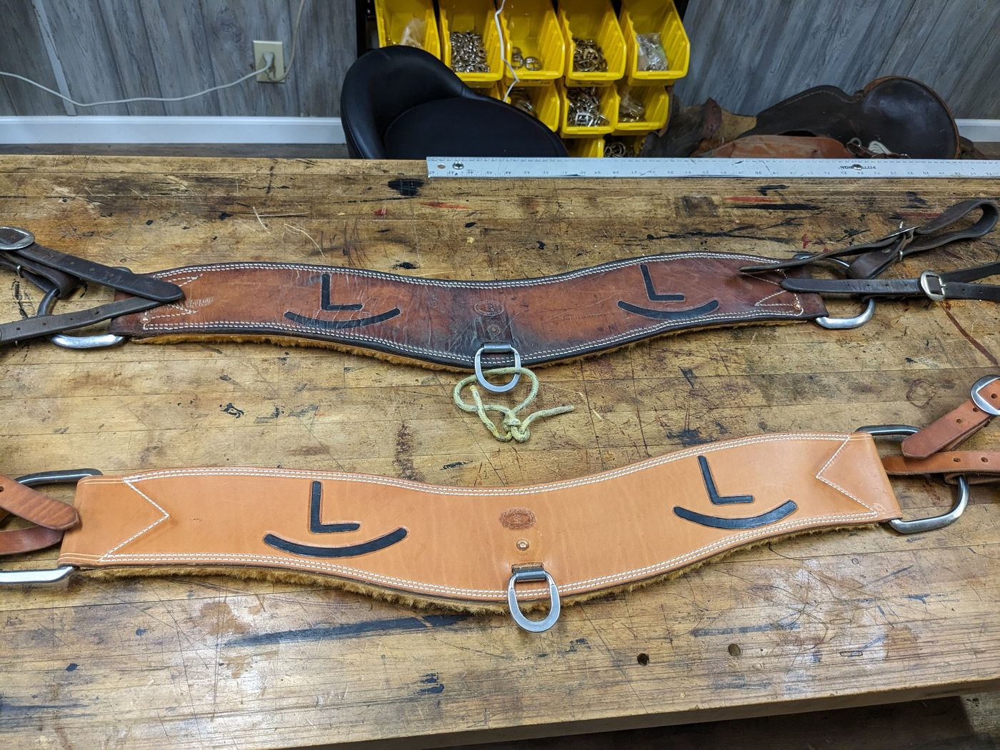Pair of leather cinches with L brands
