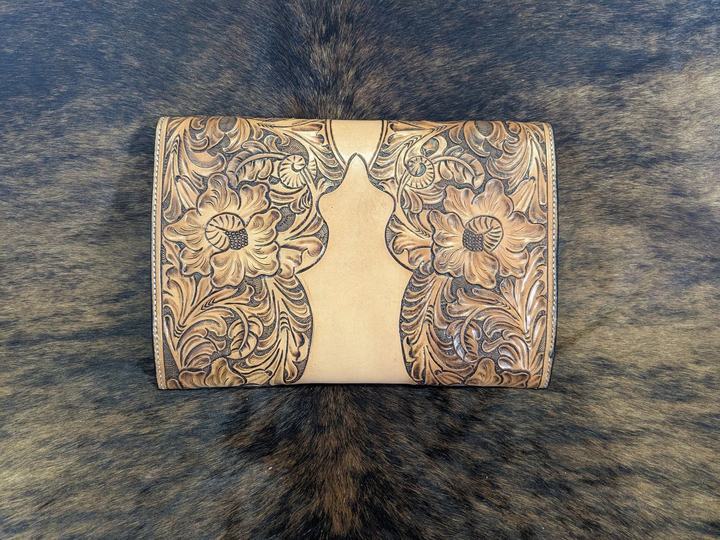 Back of floral carved leather clutch