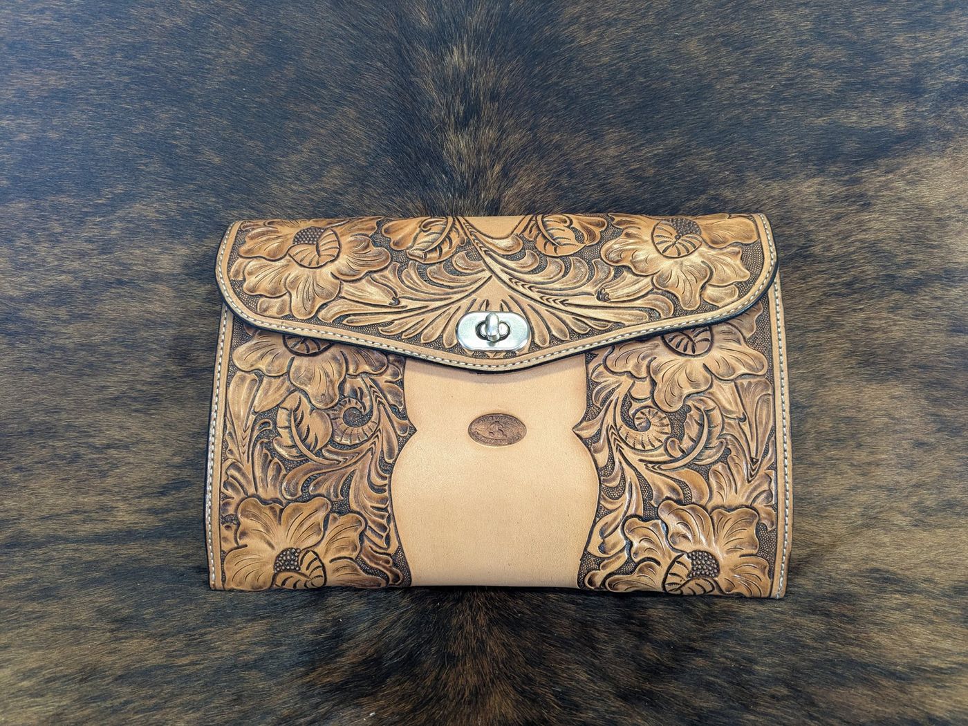 Floral carved leather clutch with turn lock