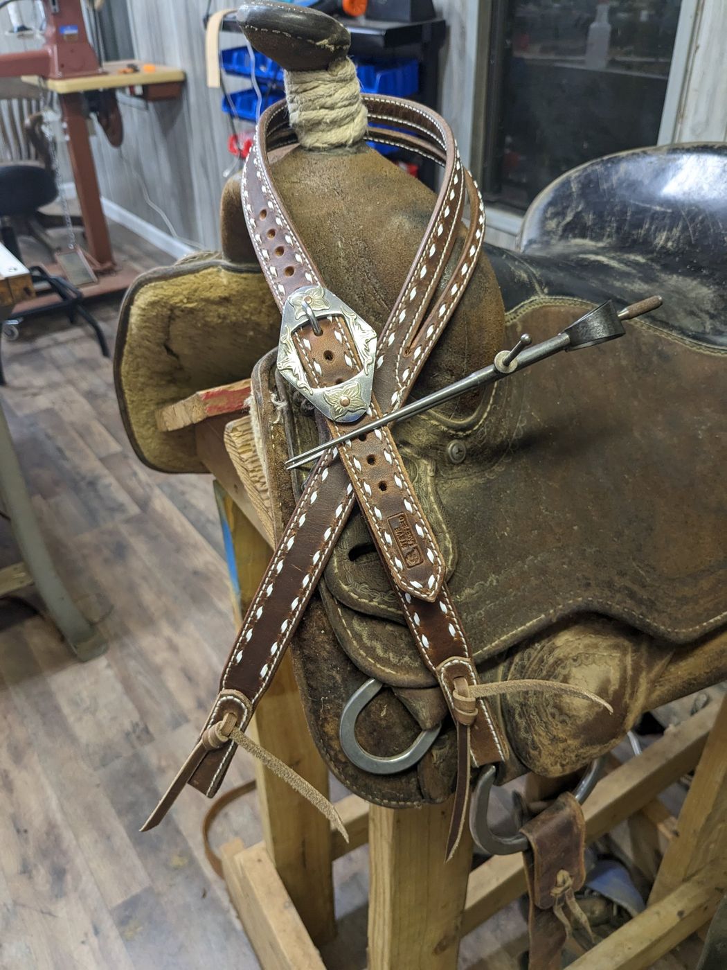 Brown headstall with white stitching and engraved silver buckle