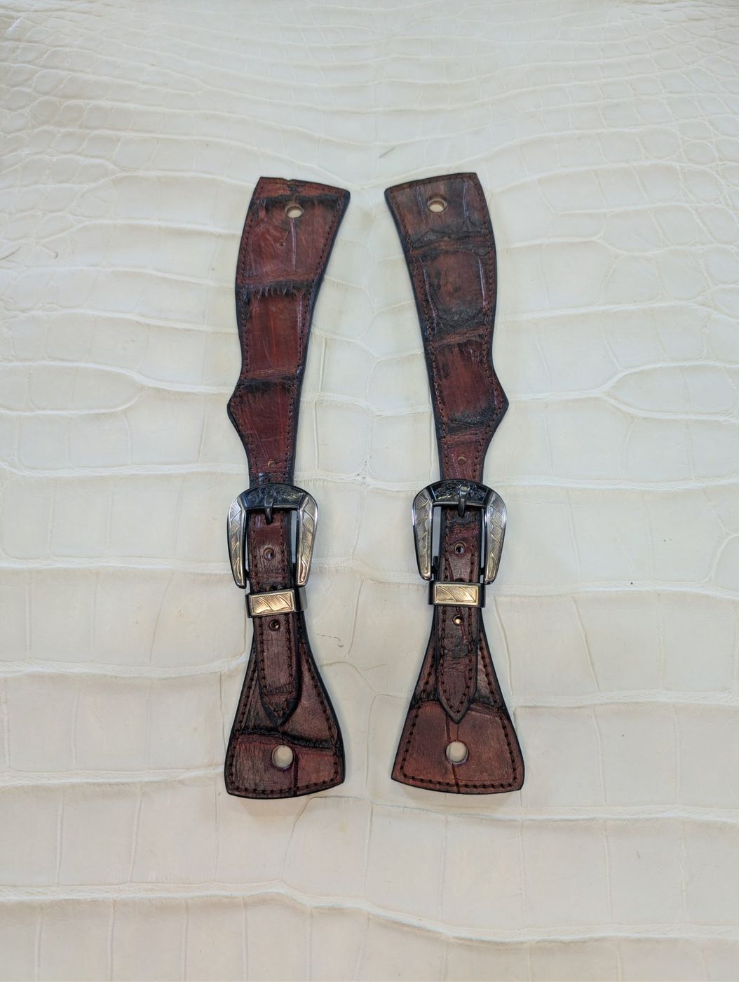 Brown gator-embossed leather spur straps with buckles
