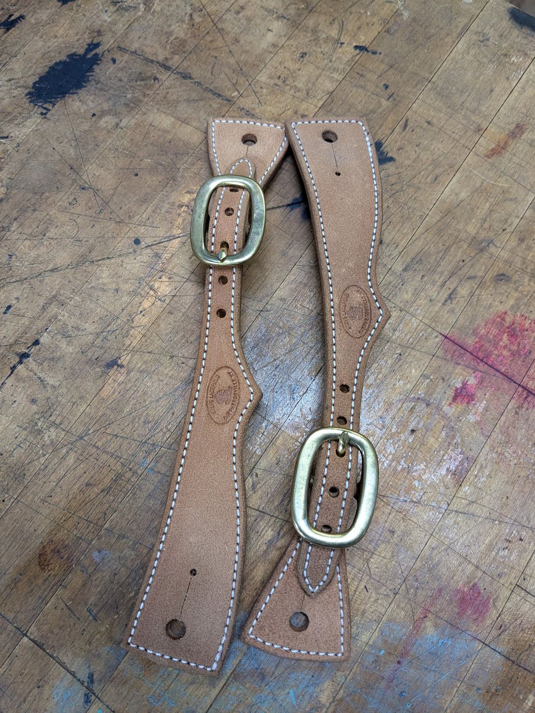 Tan roughout spur straps with brass buckles